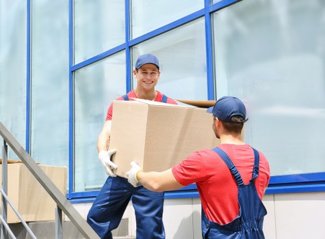 Office furniture and equipment being prepared for transport