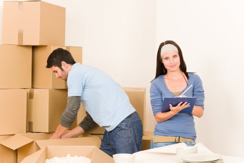 Packed boxes and furniture being loaded into a moving van